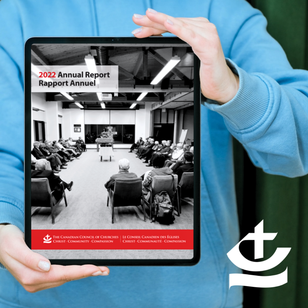 Woman holding a tablet with the cover of the 2022 Annual Report visible