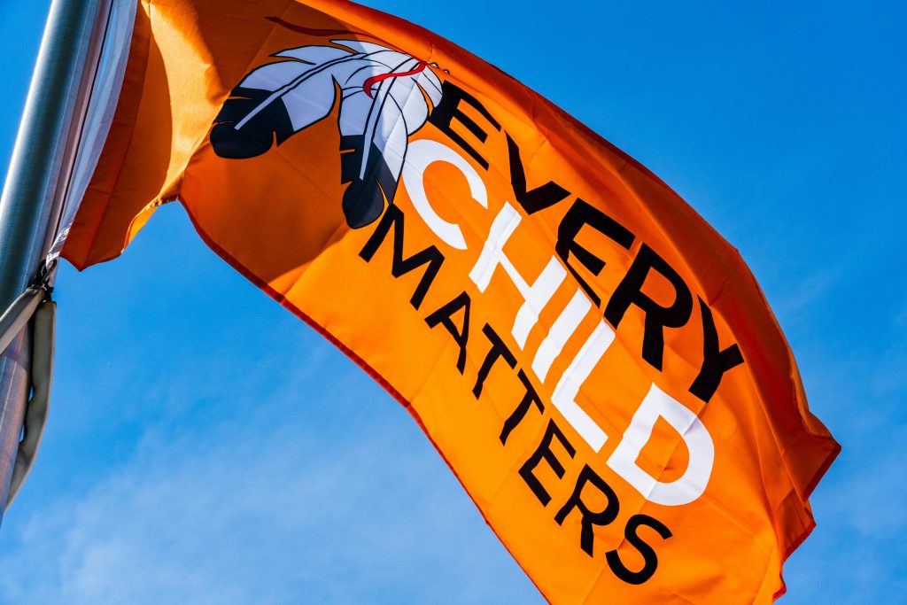 Orange flag with the writing "Every Child Matters"